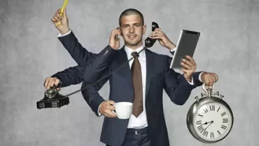 Businessman multitasking with phone, clock, and tablet.