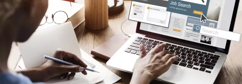 Person using a laptop for online job search.