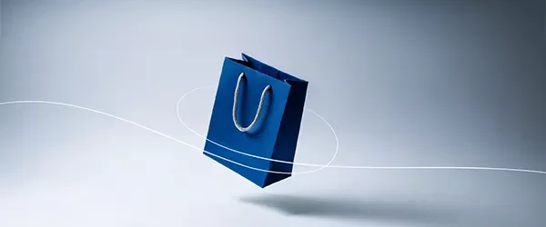 Blue shopping bag with a light gradient background